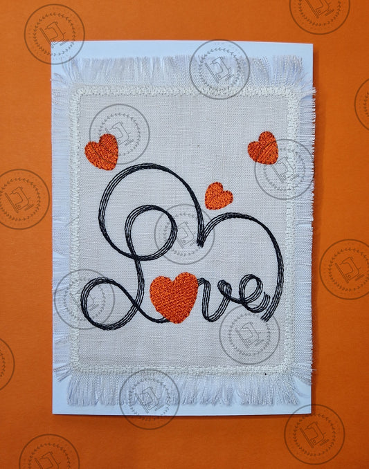 "An embroidered design featuring the word 'Love' in cursive script, stitched with black thread. The letter 'o' is shaped like a red heart, and additional red hearts are scattered decoratively around the design on a light fabric background."