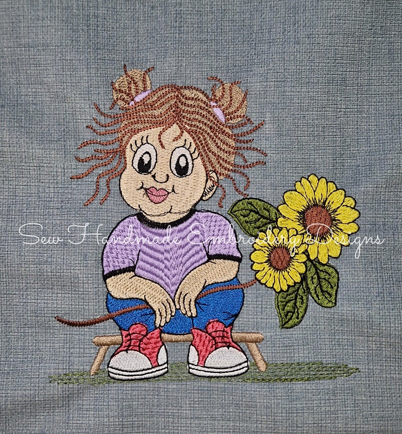 machine embroidery design stitched onto denim with a little girl holding a big sunflower and smiling cutely
