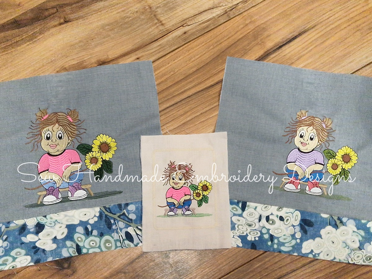 Fabric panels for a tote bag decorated with an embroidery design of a little whimsical girl and flowers