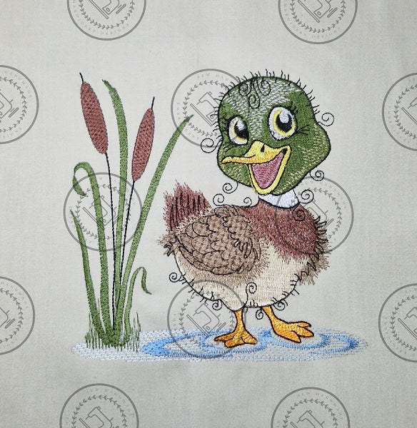 "An embroidered design of a cheerful mallard duck with a vibrant green head, brown and beige body, and yellow beak. The duck is standing in a small blue puddle next to tall cattail reeds, with a whimsical and curly detailing style."
