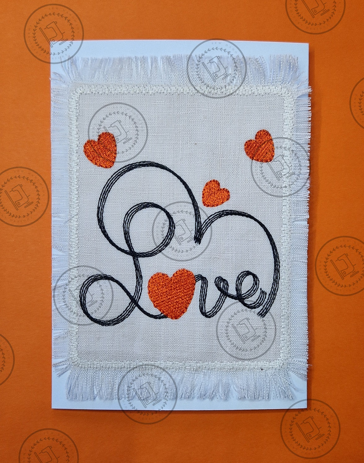 "An embroidered design featuring the word 'Love' in cursive script, stitched with black thread. The letter 'o' is shaped like a red heart, and additional red hearts are scattered decoratively around the design on a light fabric background."